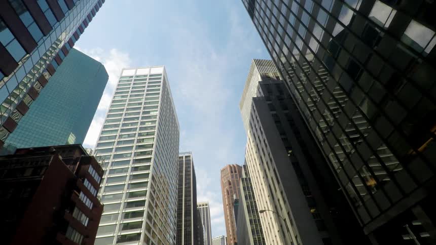 Tall city buildings with mirrored windows on a sunny day