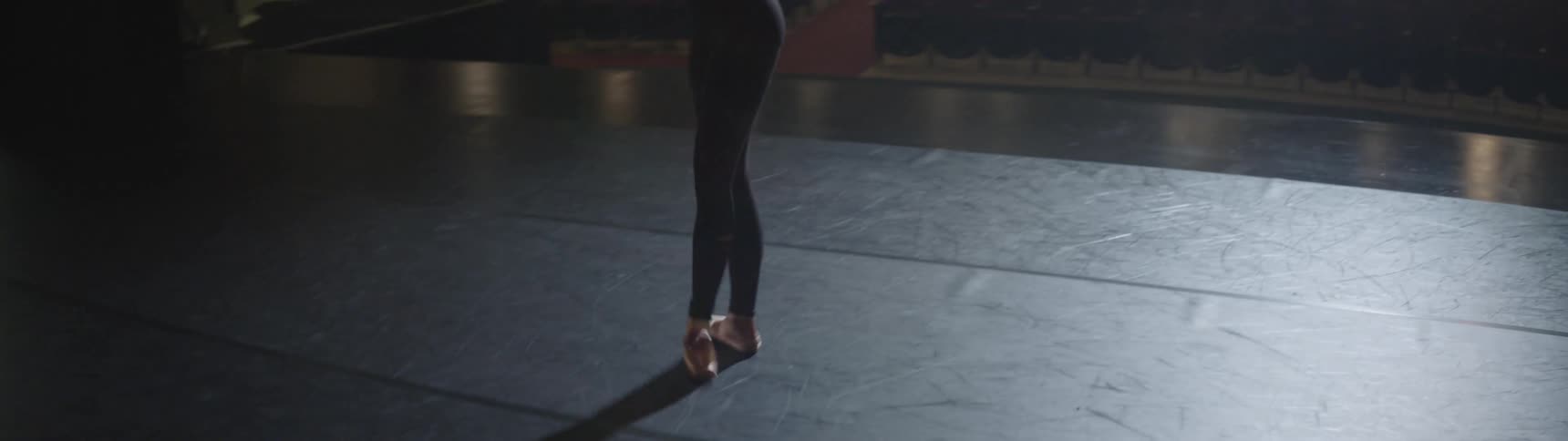 A ballerina dances on stage