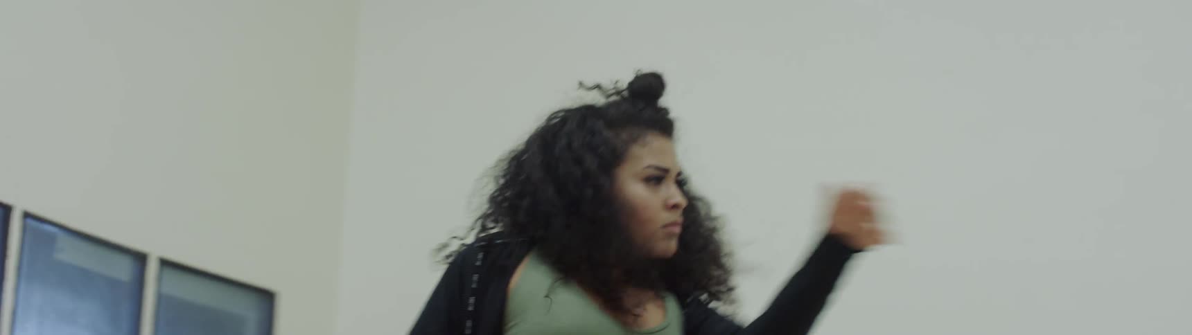 A woman dances indoors