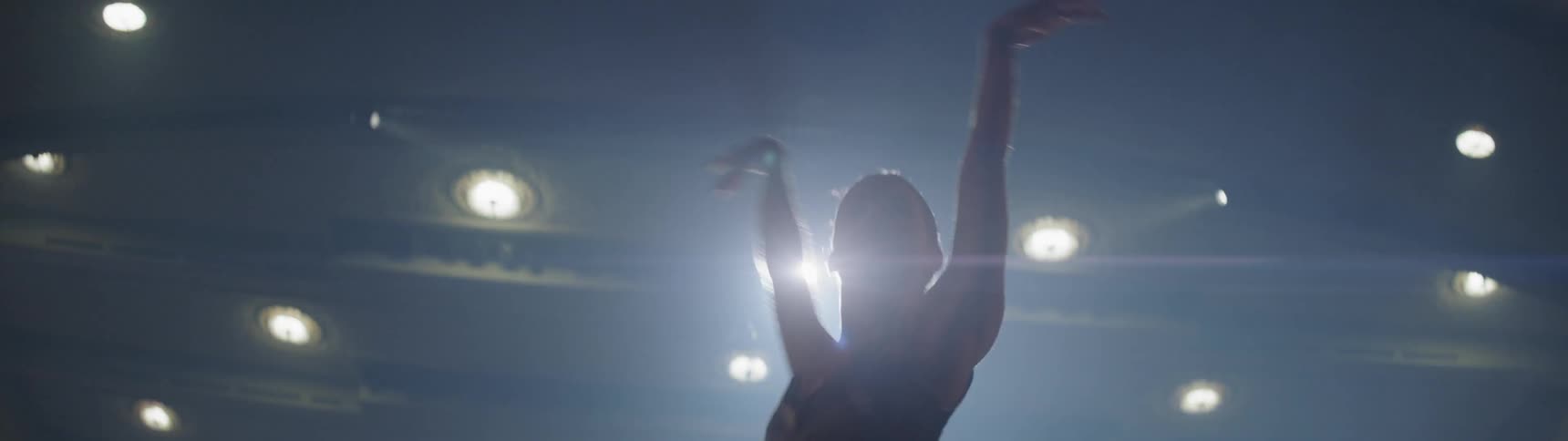 A person is dancing in a theater