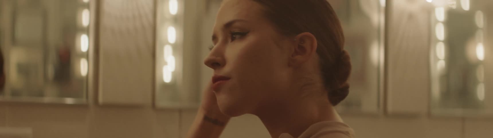 A woman checks herself out in the mirror