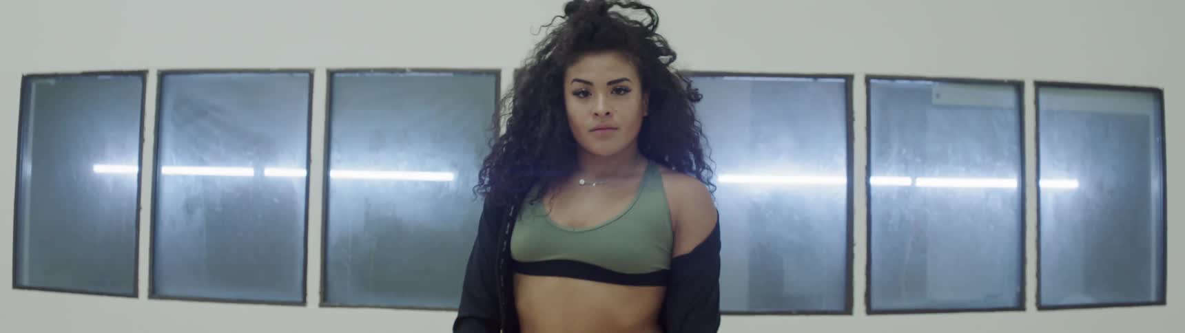A woman is dancing in front of the window