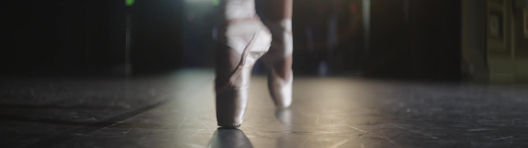 A ballerina does a repetitive dance move in a pair of pointe shoes