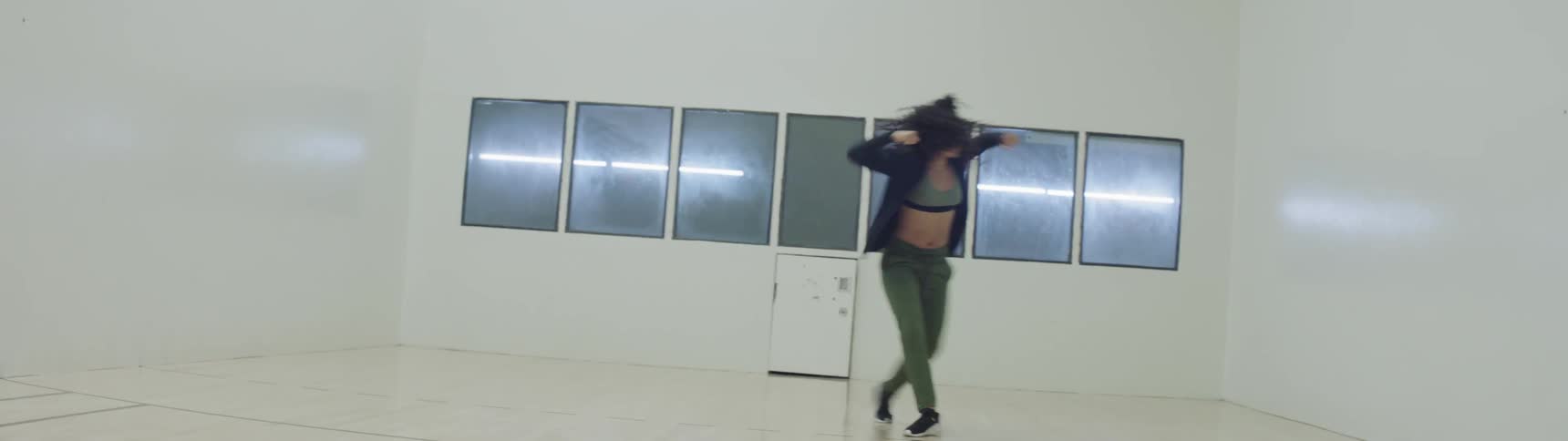 A woman is dancing indoors