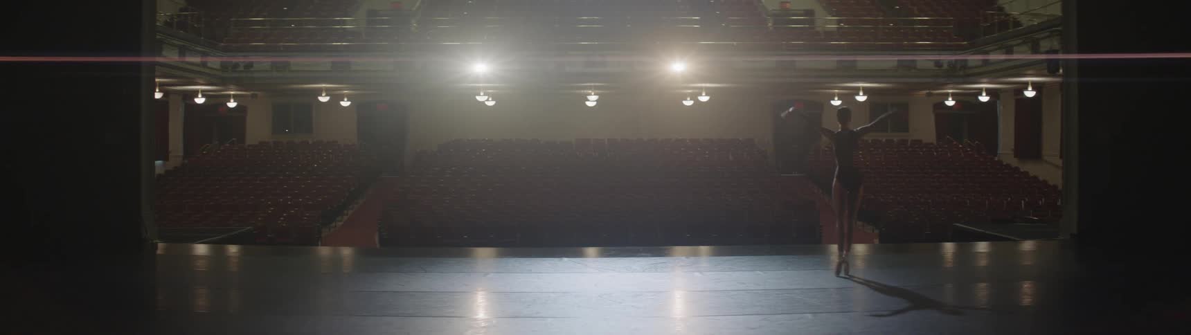 A ballerina is performing on stage