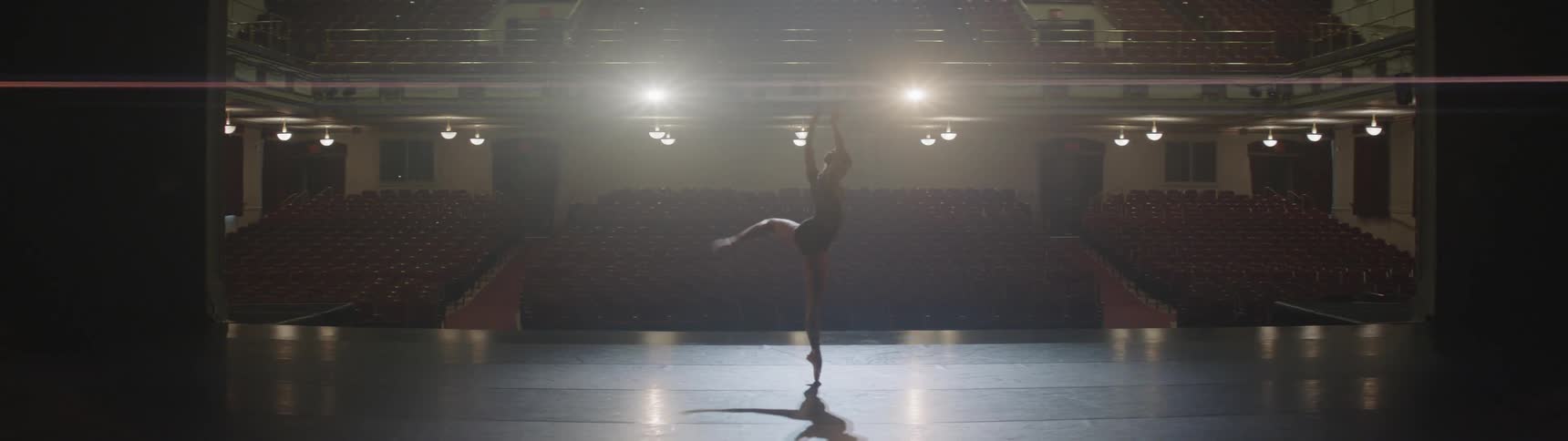 A woman is doing ballet indoors