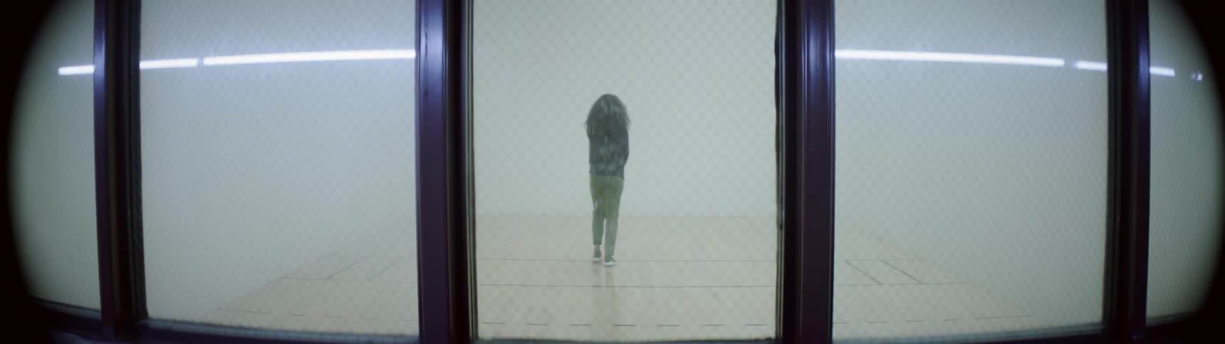A woman stretches in a room