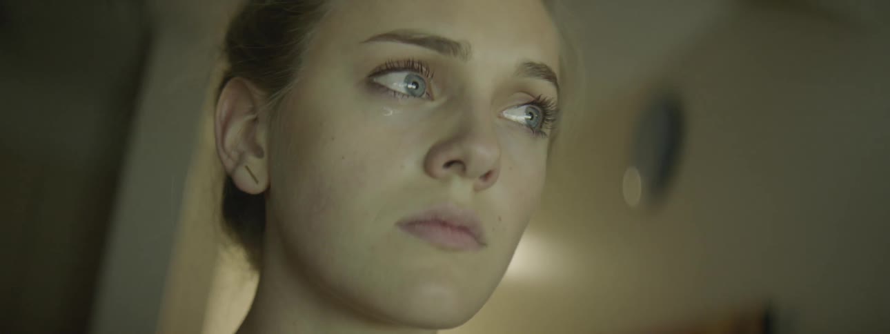 Woman crying on the hallway of a house