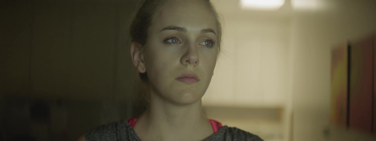 A young white woman looks like she is about to cry