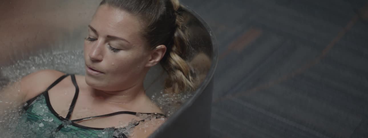 A woman soaking in an ice bath