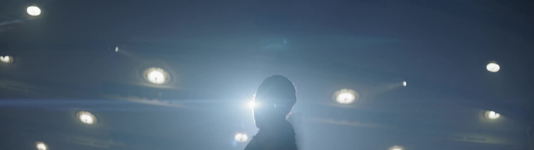 Spotlights shine on a ballerina twirling on stage