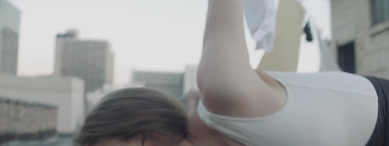 A woman is dancing outdoors
