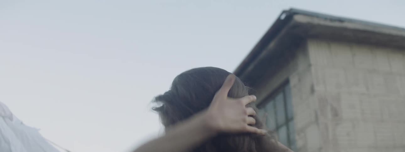 A woman dances on a rooftop