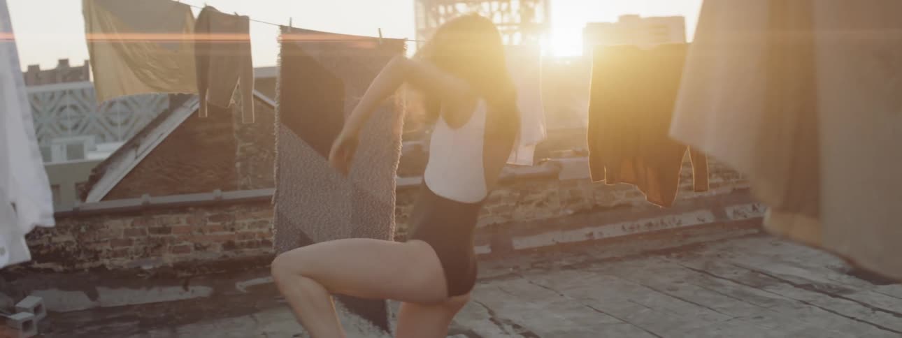 A woman is dancing on the roof