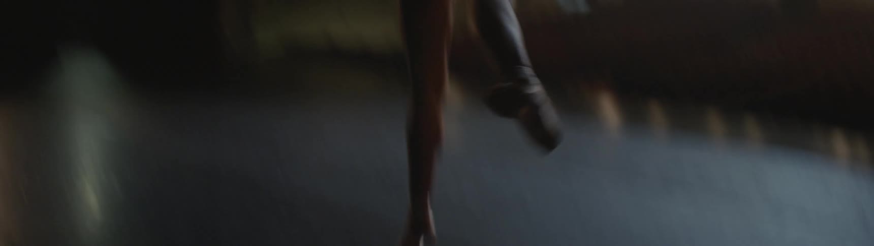 A ballet dancer en pointe on a stage in a theater