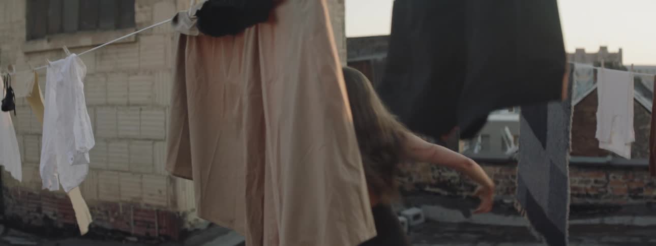 A woman is dancing outdoors in the city