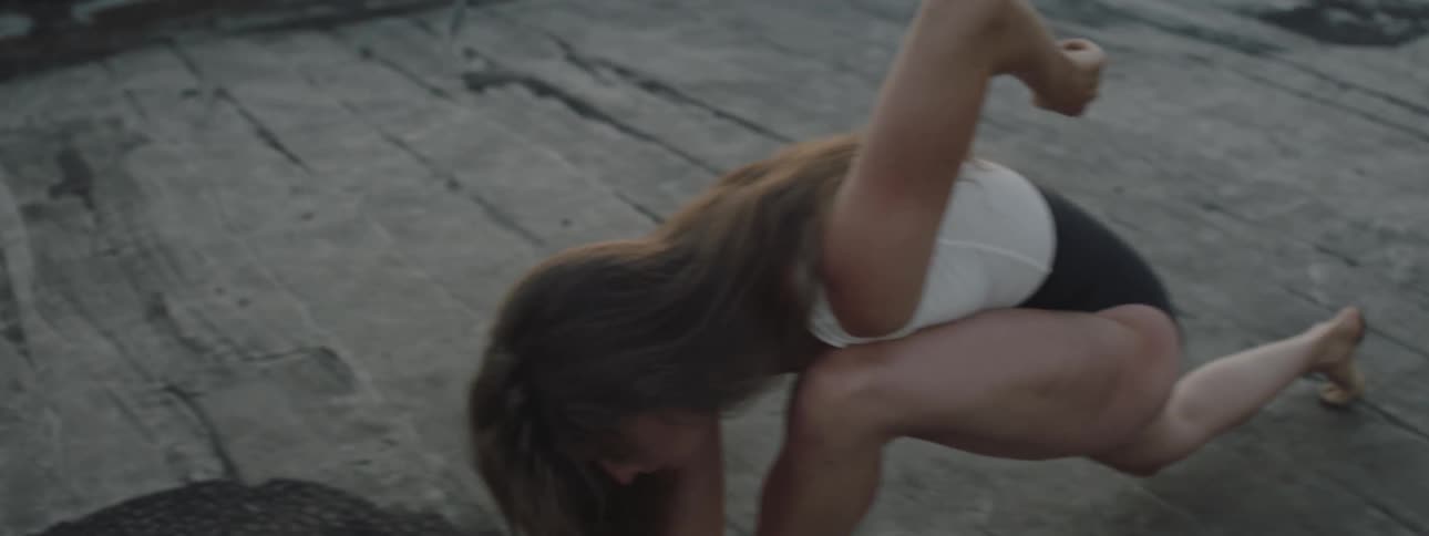 A woman is dancing outdoors