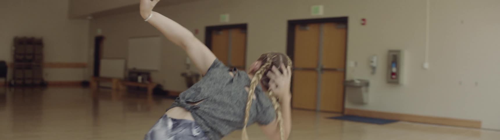 A woman dances in large room