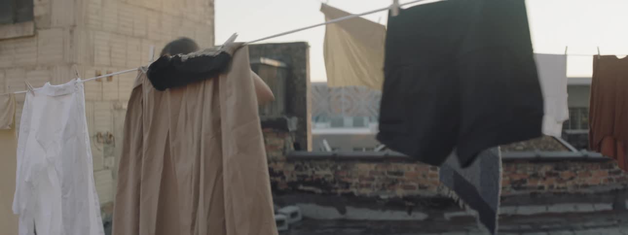 A woman is dancing outdoors in a city