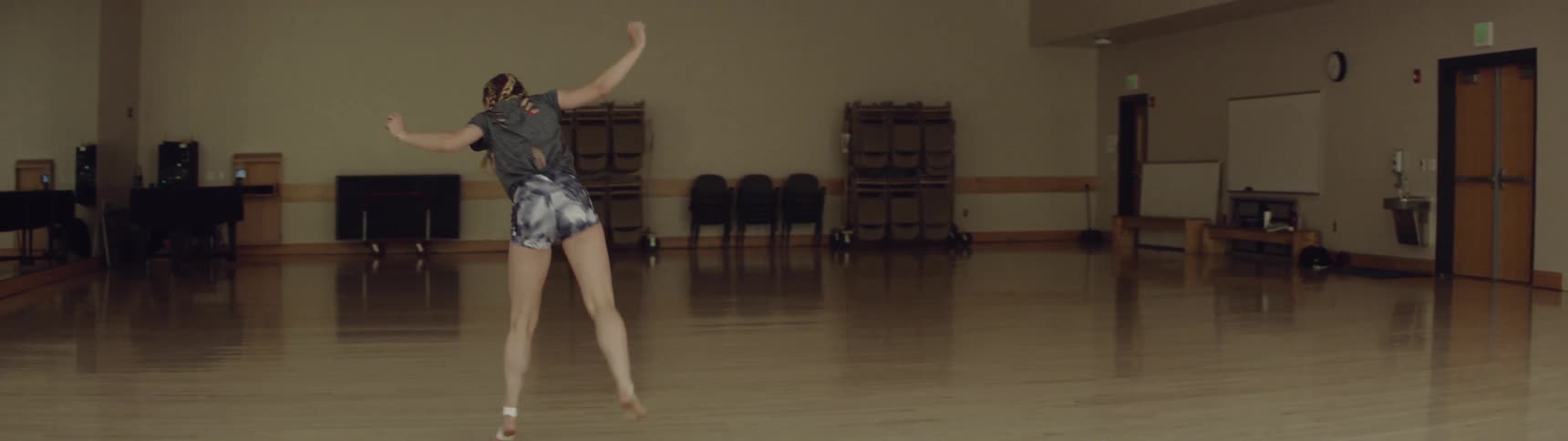 Young female dances in a large hall