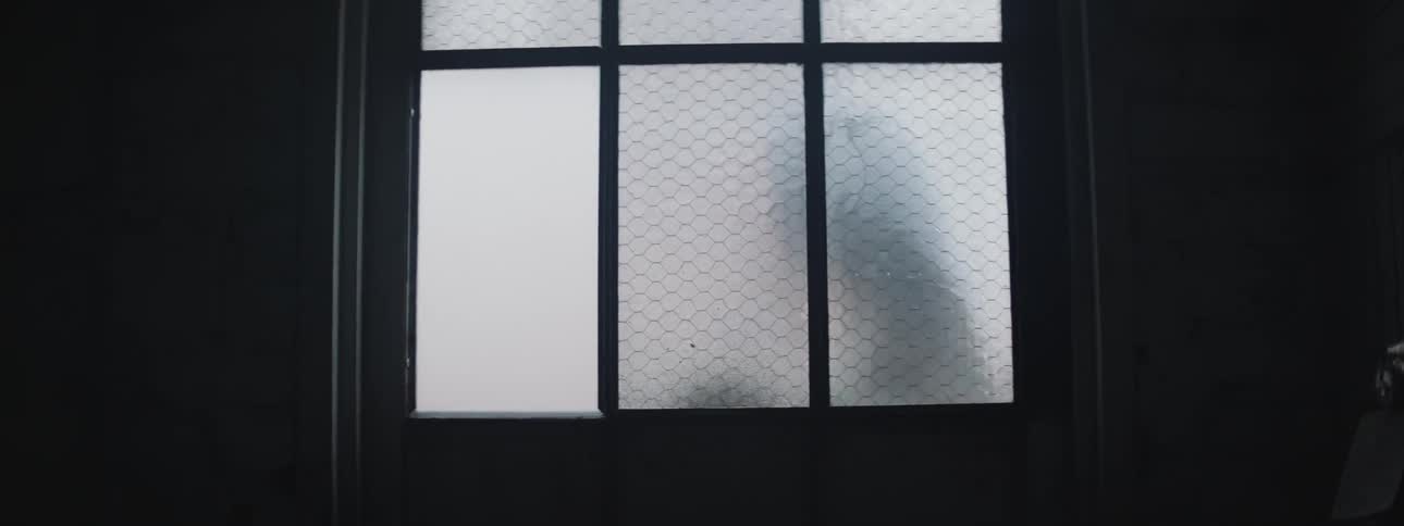 People walk passed a window