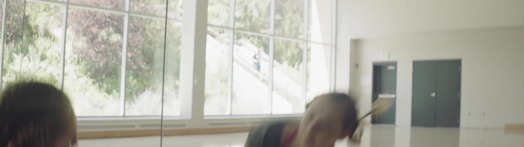 A woman is dancing in front of a mirror