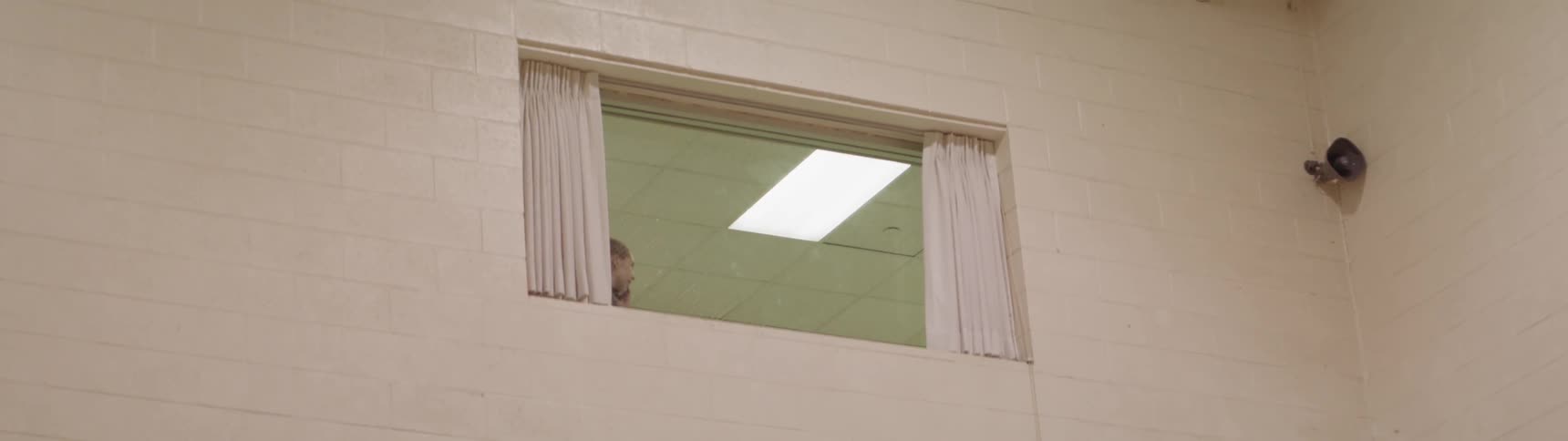 A woman by a window talking on her phone