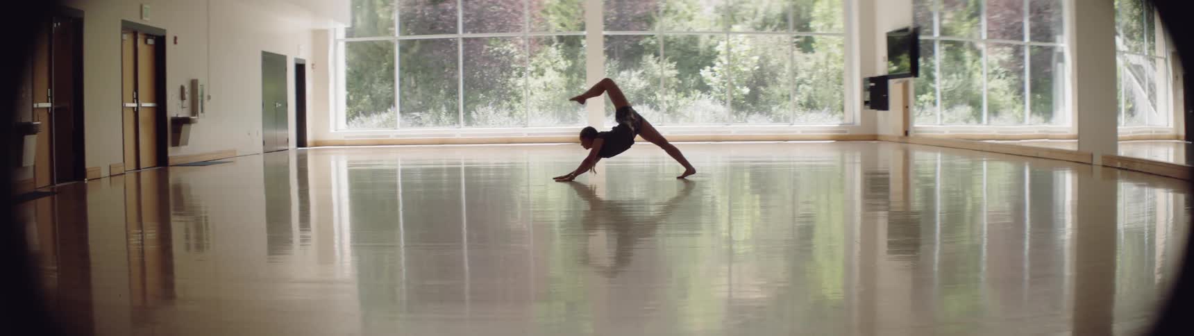 A woman stretching in a dance studio
