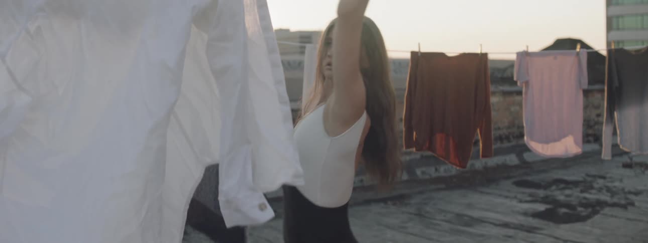 A woman is dancing outdoors