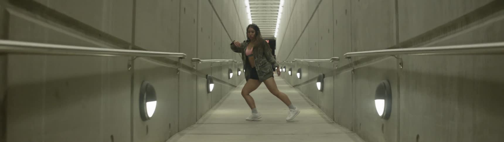 A woman dancing in a hallway
