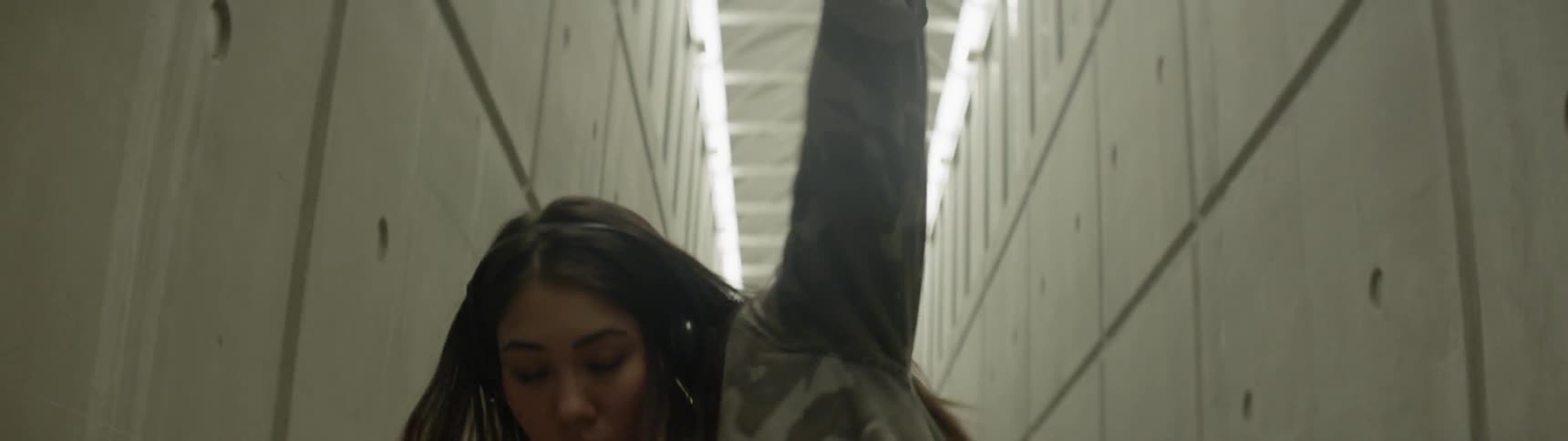 Dancer dances in long narrow corridor