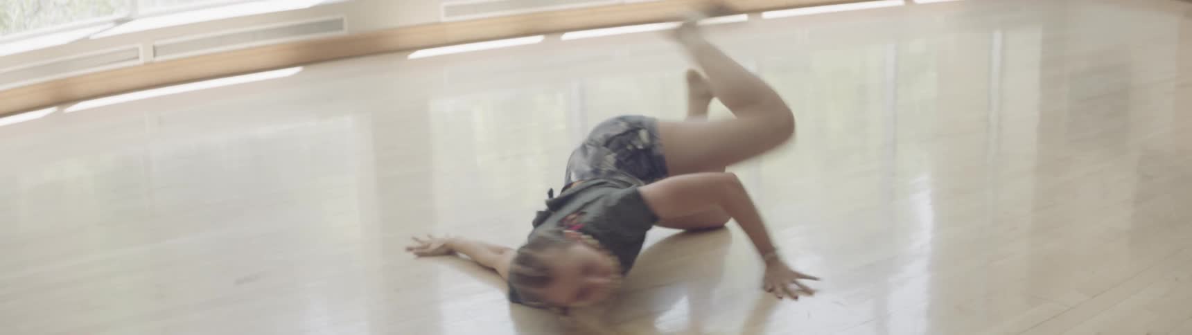 Woman performing a contemporary dance on a dance studio