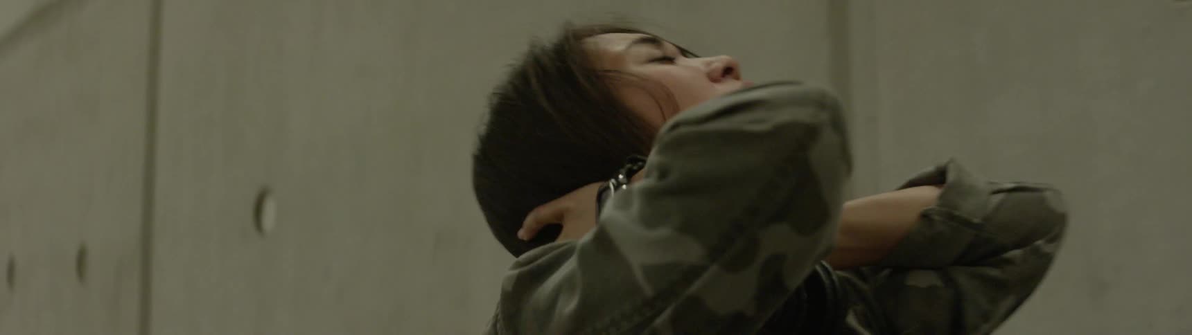 A woman holding her head and neck in pain