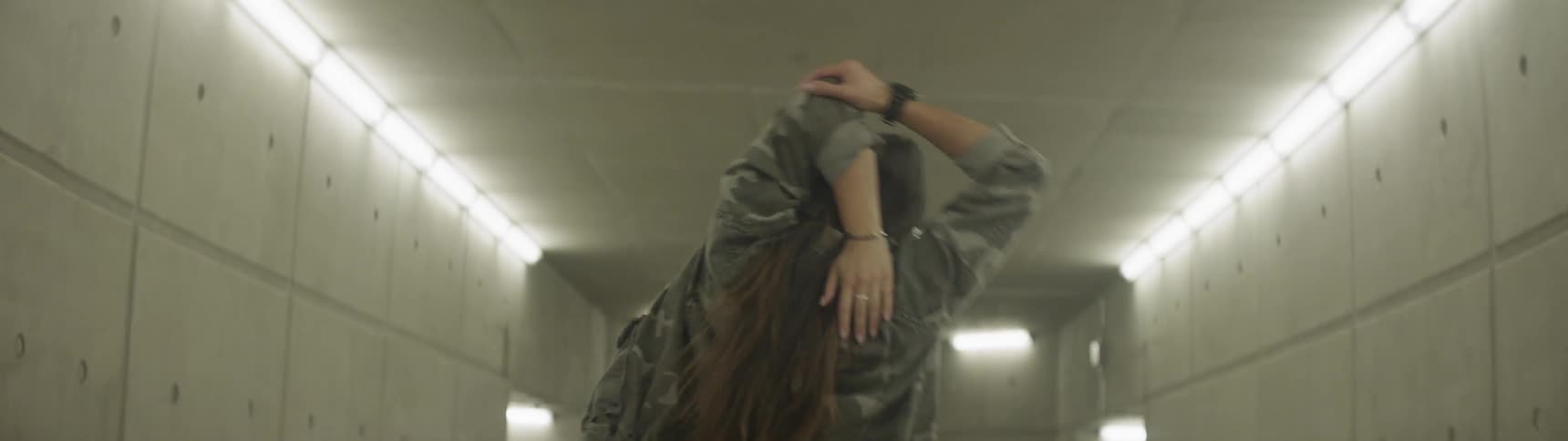 Girl warms up in the underground hall before dancing