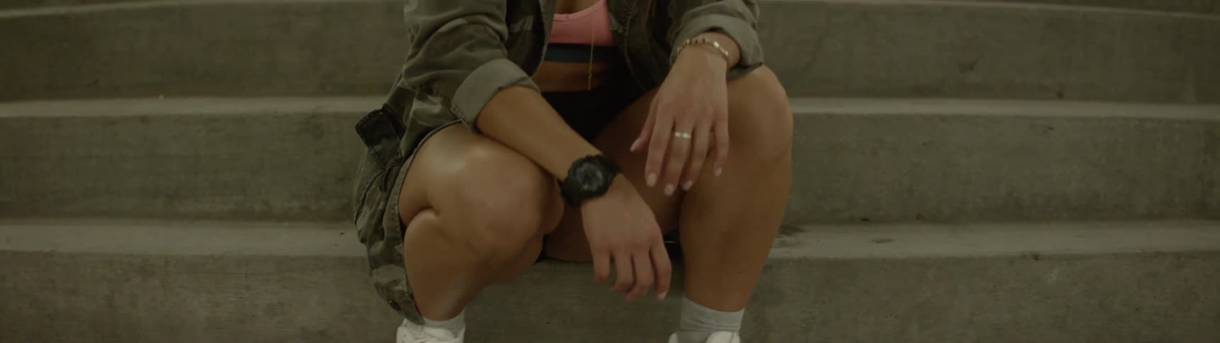 Woman in shorts sitting on stairs