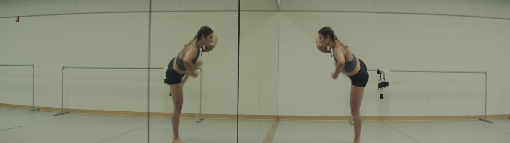 A young woman dances in a dance studio