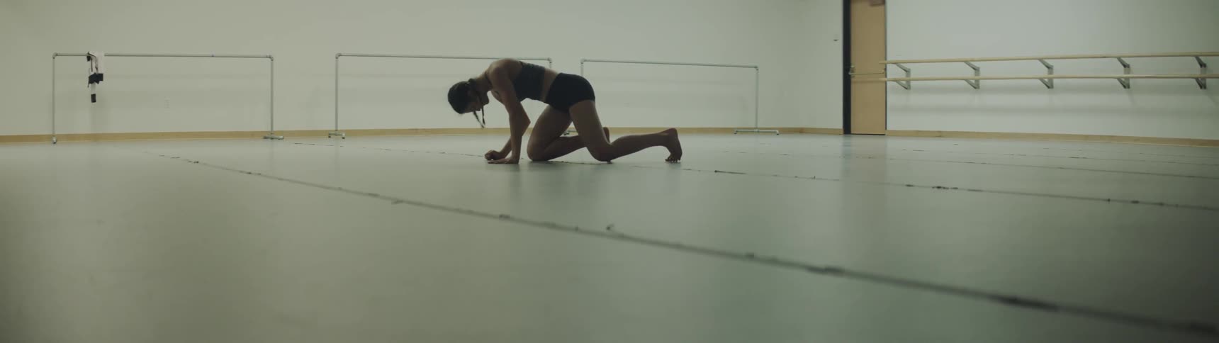 Woman practices for dance alone in the big gym