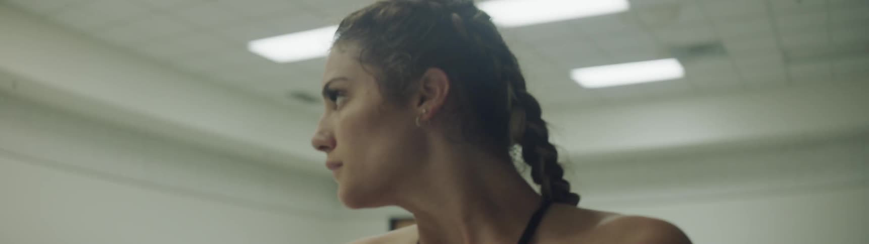 A woman is stretching in a room