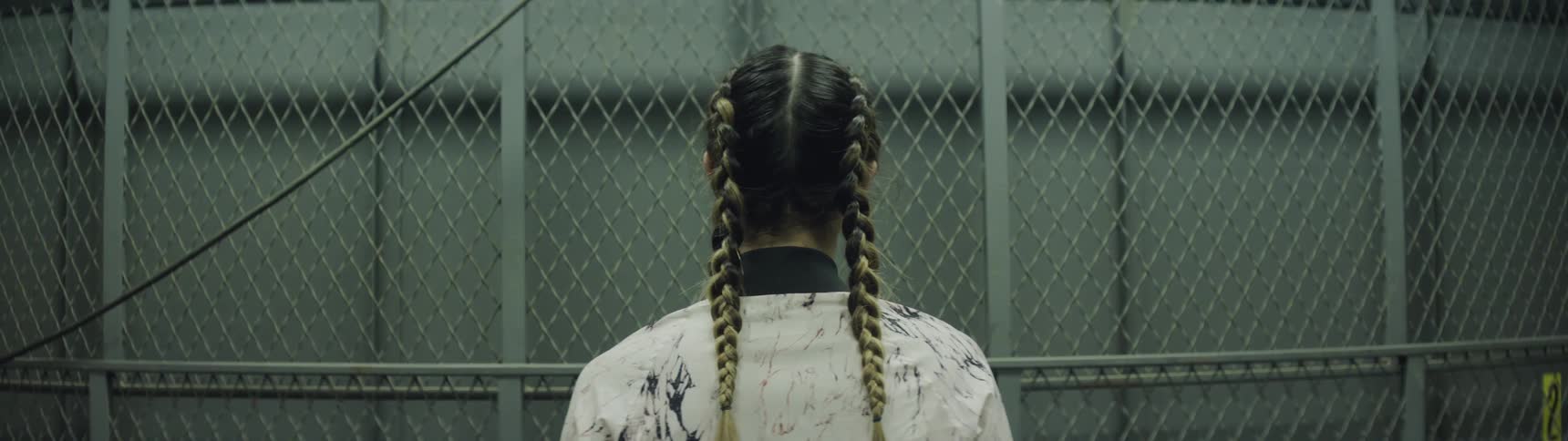 A woman with braids on a elevator going down