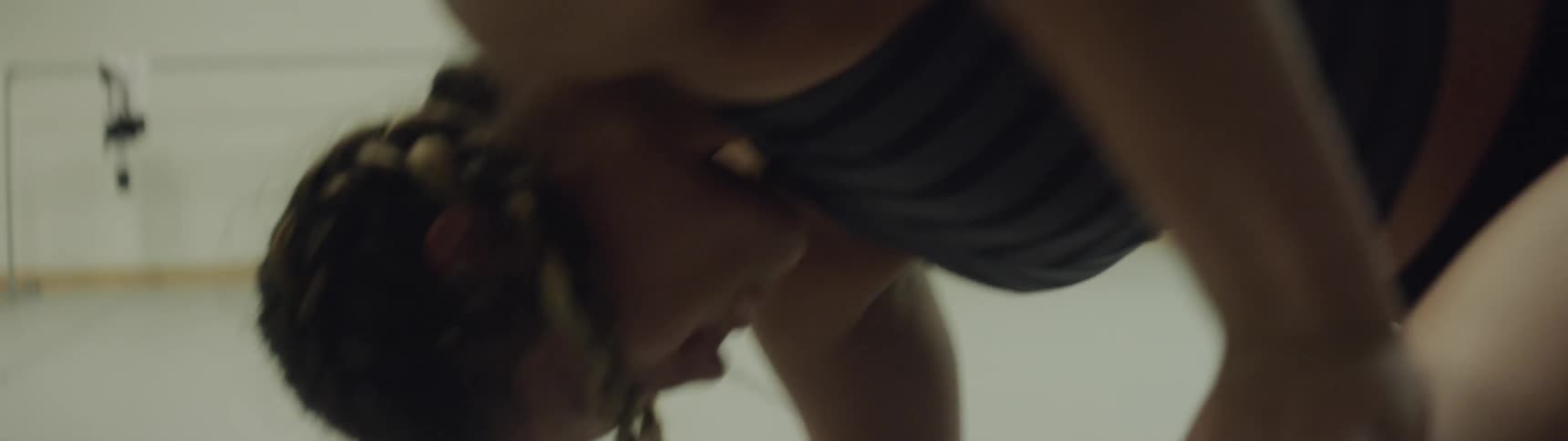 A woman is in a room dancing