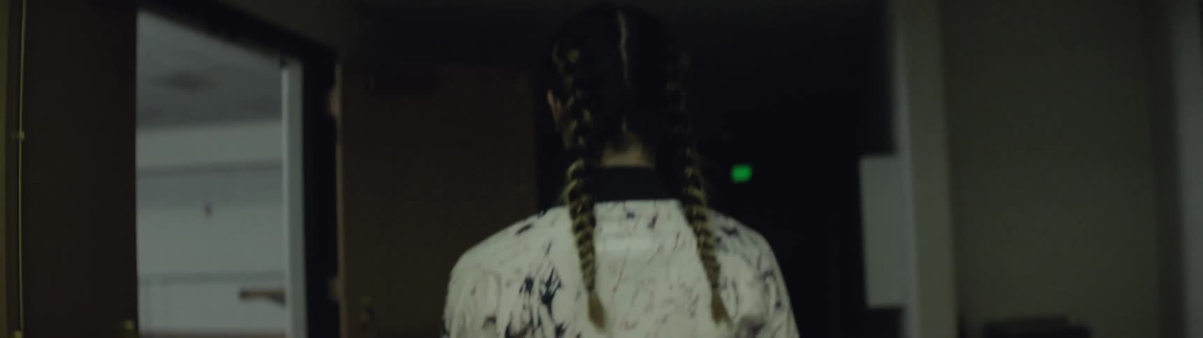 Girl with braided hair goes down in elevator and walks to big gym