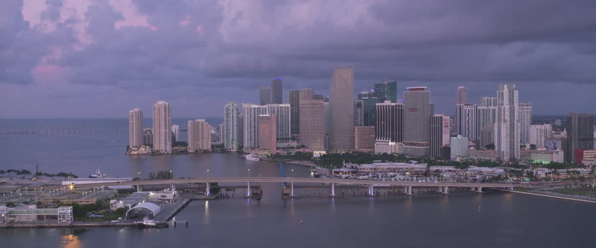 A bridge spans the distance between the downtown area of a coastal city and a smaller island adjacent to it