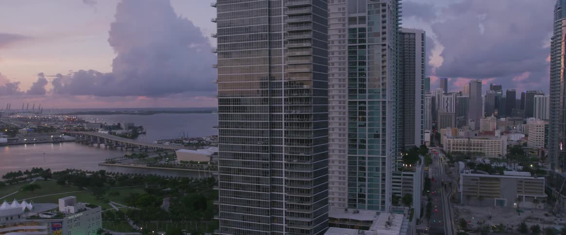 A cityscape with a body of water and the sky nearby