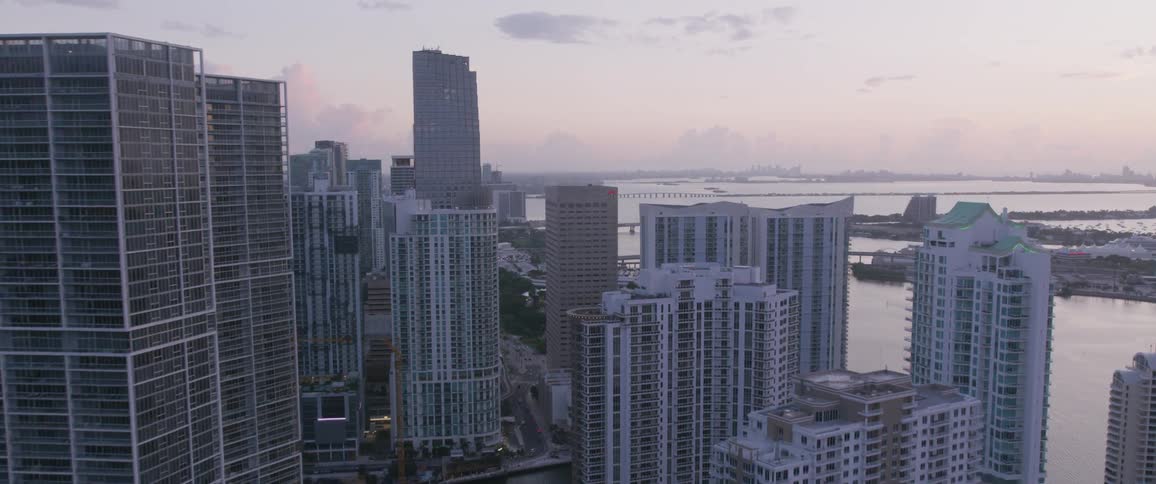 The river runs through the tall buildings