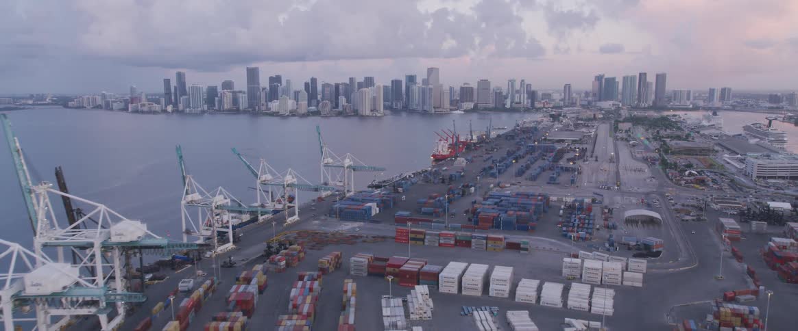 Freight containers at docks with city on horizon