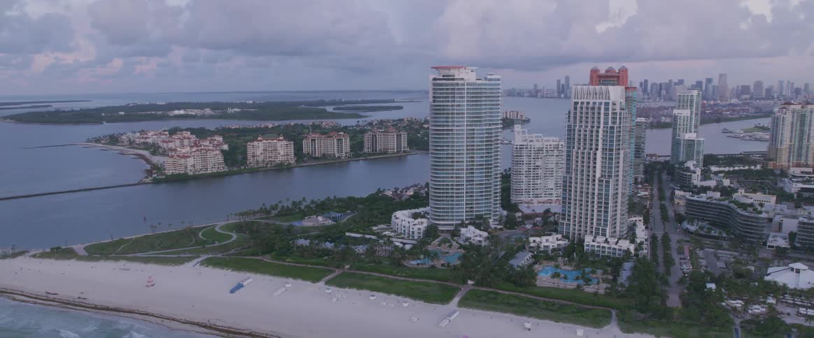 Multiple green islands beside a city coast line