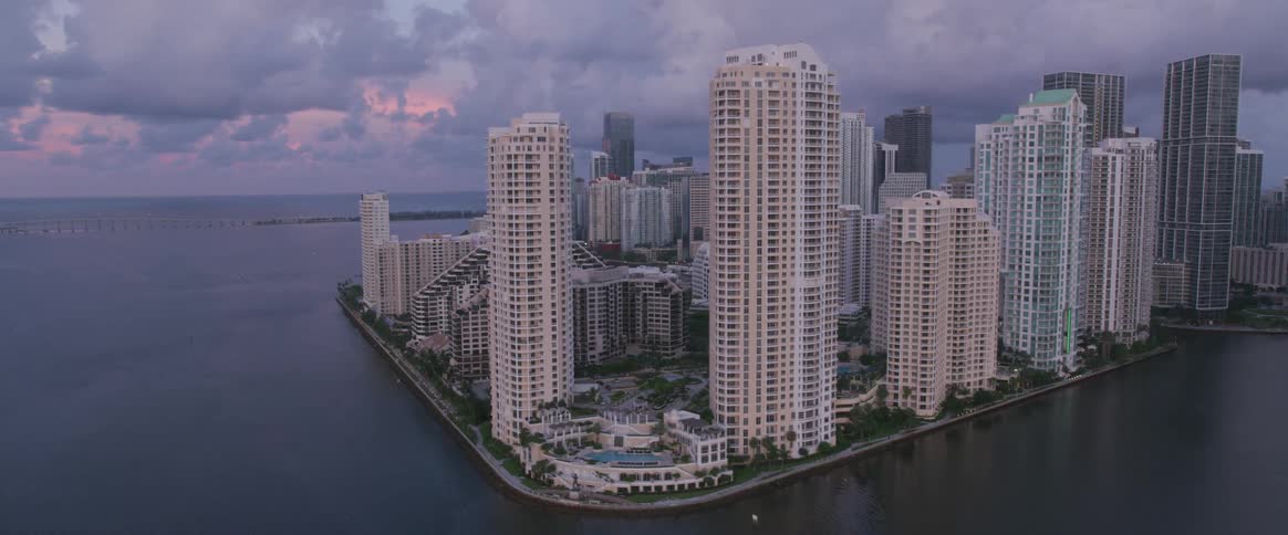 A city that is filled with countless tall skyscrapers is located next to the ocean