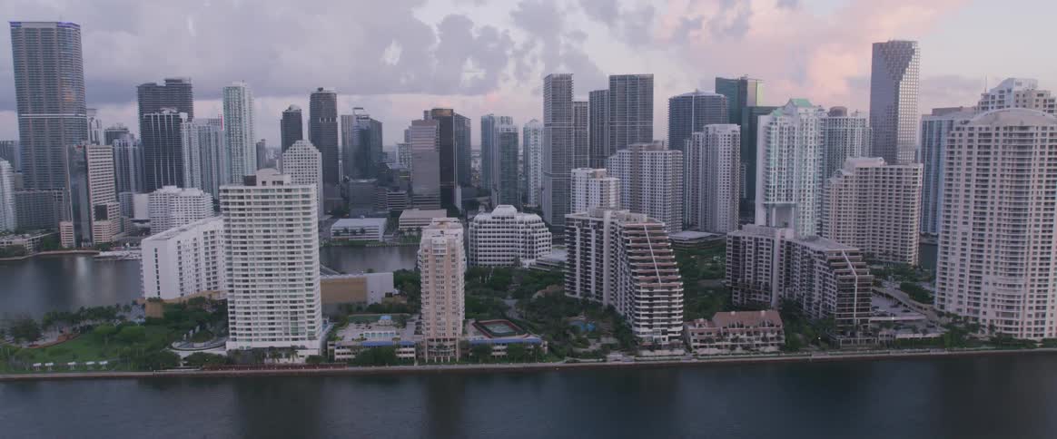 An aerial view of a cityscape that is surrounded by water