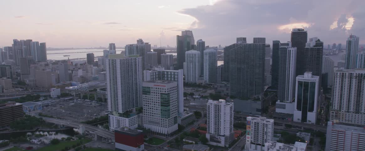 An aerial view of a city and the clouds and sky in the horizon