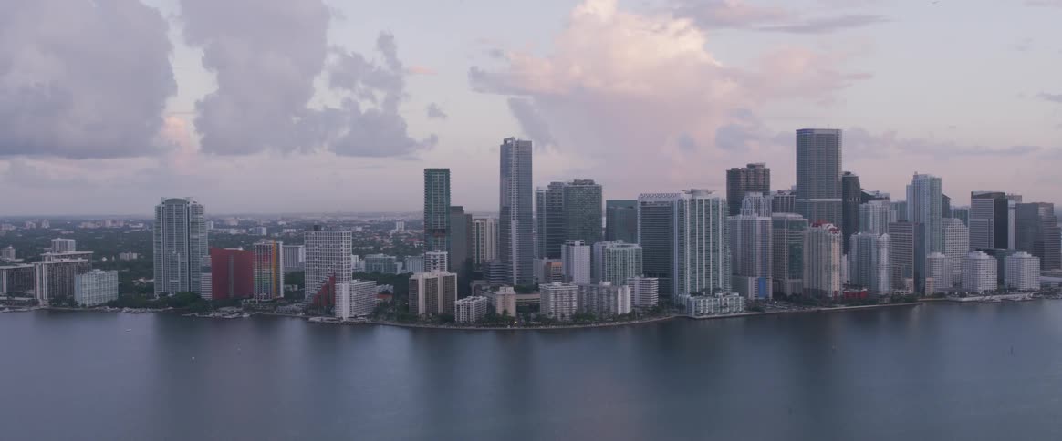 A downtown area is densely packed with numerous skyscrapers and sits along the edge of the water